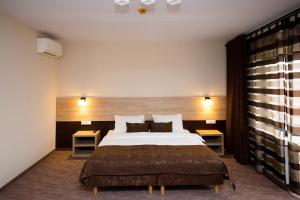 a bedroom with a large bed and two tables at Casa Baimareana in Baia Mare +41 photos