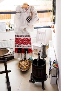 a mannequin wearing a dress and a basket of food at Casa Baimareana in Baia Mare