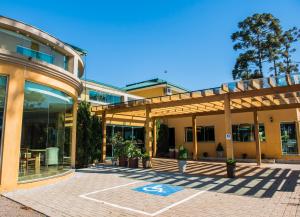 an outside view of a building with a patio at Lagoa Parque Hotel in Lagoa Vermelha