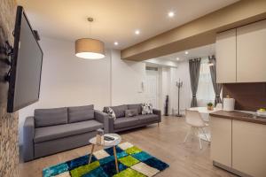 a living room with a couch and a table at Kastely Apartments - Buda Castle in Budapest