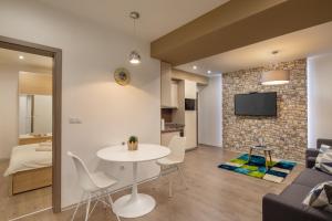 a living room and dining room with a table and chairs at Kastely Apartments - Buda Castle in Budapest