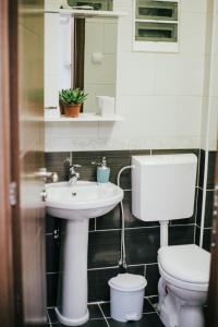 a bathroom with a sink and a toilet at White & Wood in Bitola