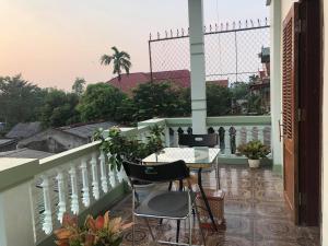 a balcony with a table and chairs on a balcony at Bach Dai Dung Hotel in Ha Tinh