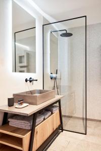 a bathroom with a sink and a shower at Kolonaki 8 - Design Suites & Lofts in Athens