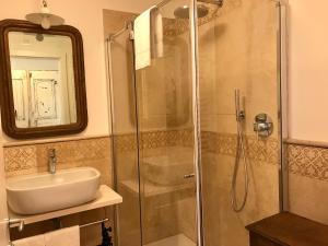 a bathroom with a shower and a sink and a mirror at Casa del Pittore in Rovereto