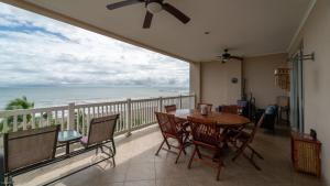 a dining room with a view of the ocean at The Palms Oceanfront Condo 604 in Jacó