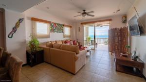 a living room with a couch and a table at The Palms Oceanfront Condo 604 in Jacó