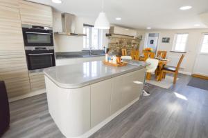 a kitchen with a large white island in a room at Sunnyside Barn in Truro