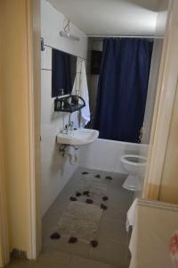 a bathroom with a sink and a toilet at Punentes Beach House in Keratokampos