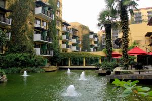 a pond in the middle of a building with fountains at Jianguo Hotel Xi'an in Xi'an