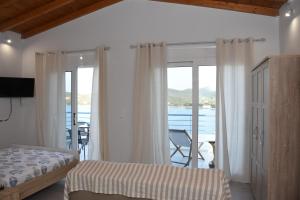 a bedroom with a bed and a view of the ocean at Sofia's view in Amaliápoli