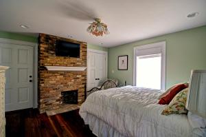 a bedroom with a bed and a fireplace at Fort Conde Inn - Mobile in Mobile