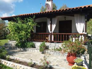 a house with a porch and a patio at Vourvourou Antonis House in Vourvourou