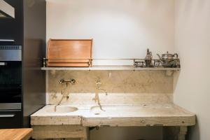 a bathroom with a stone sink in a room at Flat Two in Rome