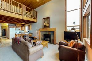 a living room with two couches and a fireplace at Arolla Chalet D in Big White