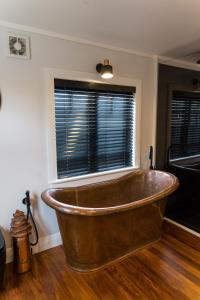 a copper tub in a room with a window at York House in Russell