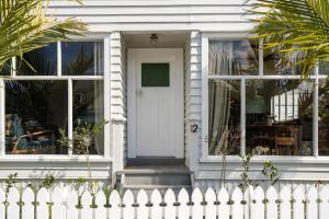 a white house with a white door and windows at York House in Russell