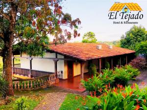 a house with a tile roof and a porch at El Tejado in Suchitoto +38 photos