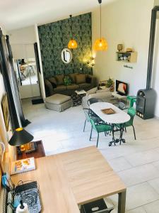 ein Wohnzimmer mit einem Tisch und einem Sofa in der Unterkunft Maison de Campagne by La Boîte En Plus in Senlis