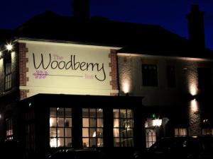 Ein Gebäude mit dem Woodleigh Inn leuchtet nachts in der Unterkunft Woodberry Inn in Bridgnorth