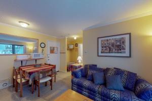 a living room with a couch and a table at Snow Ghost Inn 326 in Big White