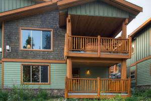 a house with a large deck on the side of it at Silver Tip 6 in Big White