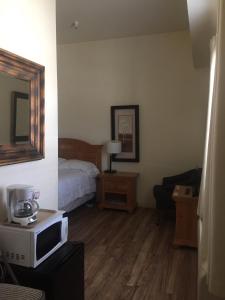 a hotel room with a bed and a microwave at Whitney Portal Hotel And Hostel in Lone Pine