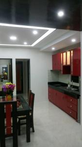 a kitchen with a black table and red cabinets at Tagaytay Suite 2 in Tagaytay