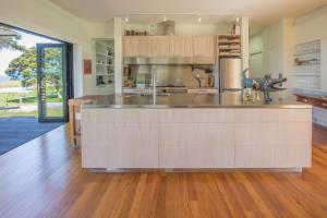 a kitchen with a large island in the middle at Lansdowne Farm Lodge in Hawkeswood