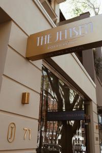 a building with a sign for the jenner roots point at The Jensen Potts Point in Sydney