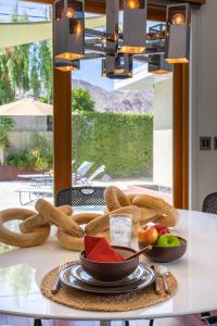 a table with a plate of food on it at tHe PRESIDENTIAL HOUSE: EXCLUSIVE MOUNTAIN VIEWS & AMENITIES in La Quinta