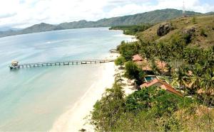 a view of a beach with a pier in the water at Cocotinos Sekotong Lombok in Sekotong