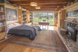 a bedroom with a bed and a desk and a fireplace at Lansdowne Farm Lodge in Hawkeswood