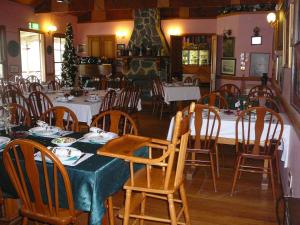 a dining room with tables and chairs in a restaurant at Bestbrook Mountain Farmstay in Maryvale