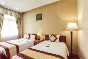 Giường trong phòng chung tại Cong Doan Thanh Binh Hotel