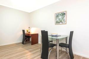 a dining room with a table and chairs at Perth West End Apartment 601 in Perth