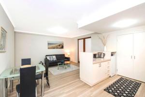 a living room with a kitchen and a dining room at Perth West End Apartment 601 in Perth