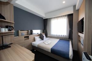 En eller flere senge i et værelse på Quintessa Hotel Osaka Shinsaibashi Comic & Books