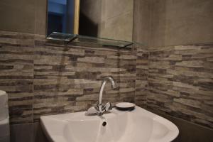 a bathroom with a sink and a mirror at Cozy Studio, Athens city center in Athens