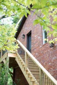 a brick building with a staircase and a window at The Henry Carriage House in Bentonville