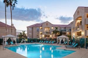 basen w hotelu z niebieskimi krzesłami i palmami w obiekcie Hyatt House Scottsdale Old Town w mieście Scottsdale