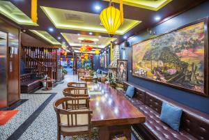 a restaurant with a long wooden table and chairs at SAPA FULL HOUSE HOTEL in Sapa