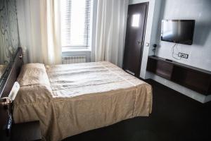 Voodi või voodid majutusasutuse Letuchaya Mysh Hotel toas