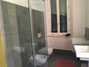a bathroom with a shower and a toilet and a sink at Chez Anna in Iesi