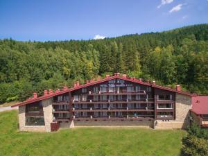 a large building in the middle of a field at Hotel Villa Magus in Kladnitsa