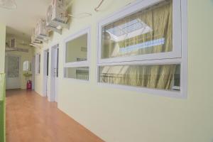 an empty hallway of a hospital with windows at RedDoorz Syariah near Museum Wisma Karya Subang in Subang