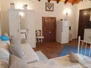 a living room with a couch and a refrigerator at Furaha Villa Etna Trecastagni in Trecastagni