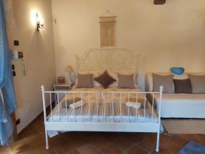 a bedroom with a white bed with pillows on it at Furaha Villa Etna Trecastagni in Trecastagni