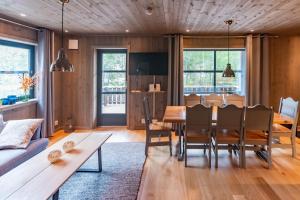 a dining room with a wooden table and chairs at Trysiltunet 16b in Trysil