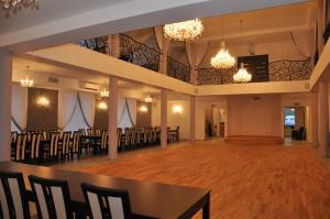 a large banquet hall with tables and chairs and chandeliers at Villa Szamocin in Warsaw